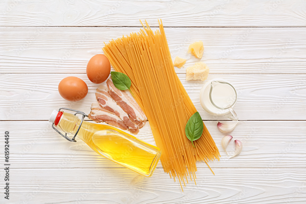 Ingredients for tasty pasta carbonara on light wooden background