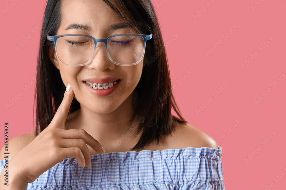 Beautiful Asian woman in stylish eyeglasses on pink background, closeup