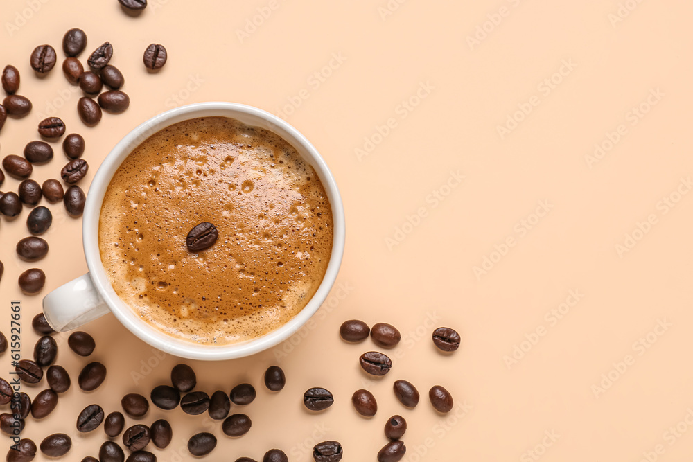 Cup of hot espresso and coffee beans on beige background