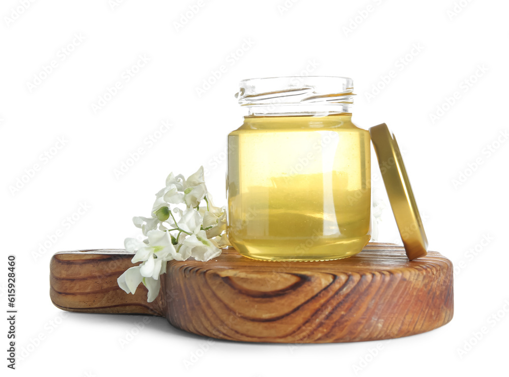 Jar of honey with flowers of acacia on white background