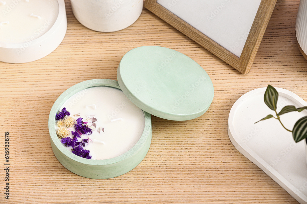 Holder with candle and decor on wooden background, closeup