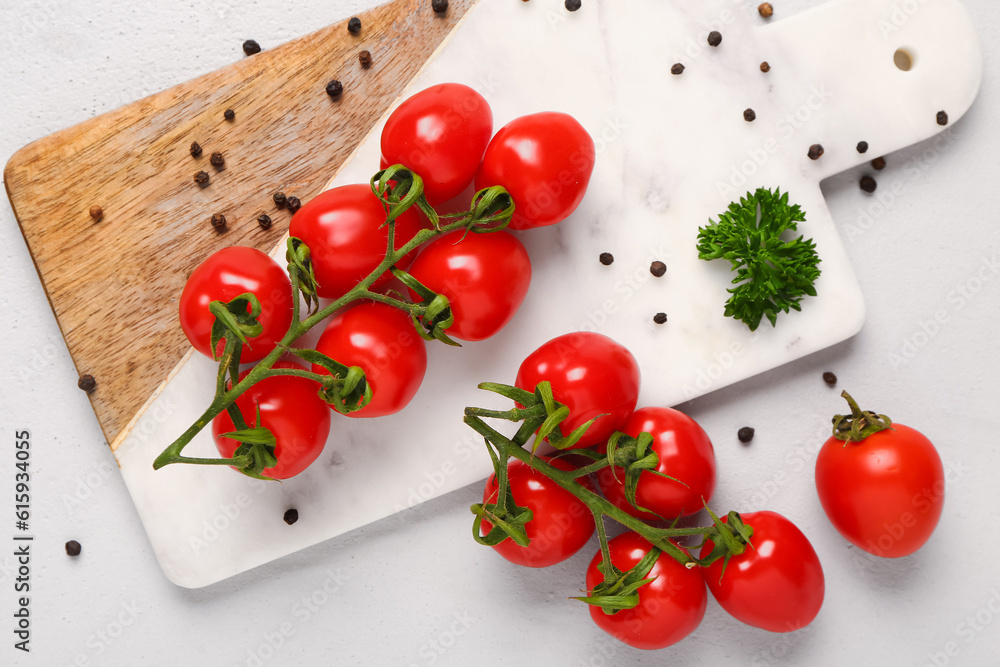 Board with fresh cherry tomatoes and peppercorn on white background