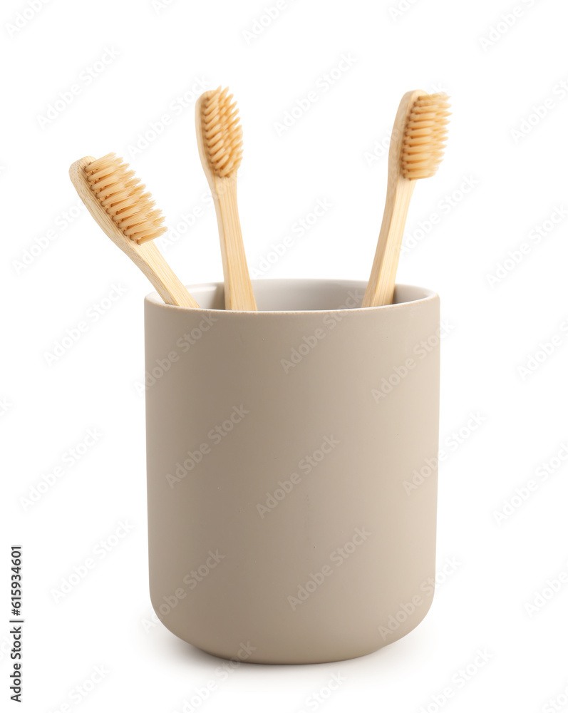 Bamboo tooth brushes in holder on white background