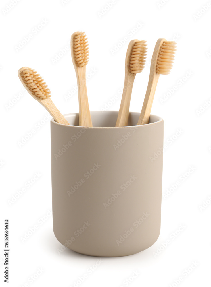 Bamboo tooth brushes in holder on white background