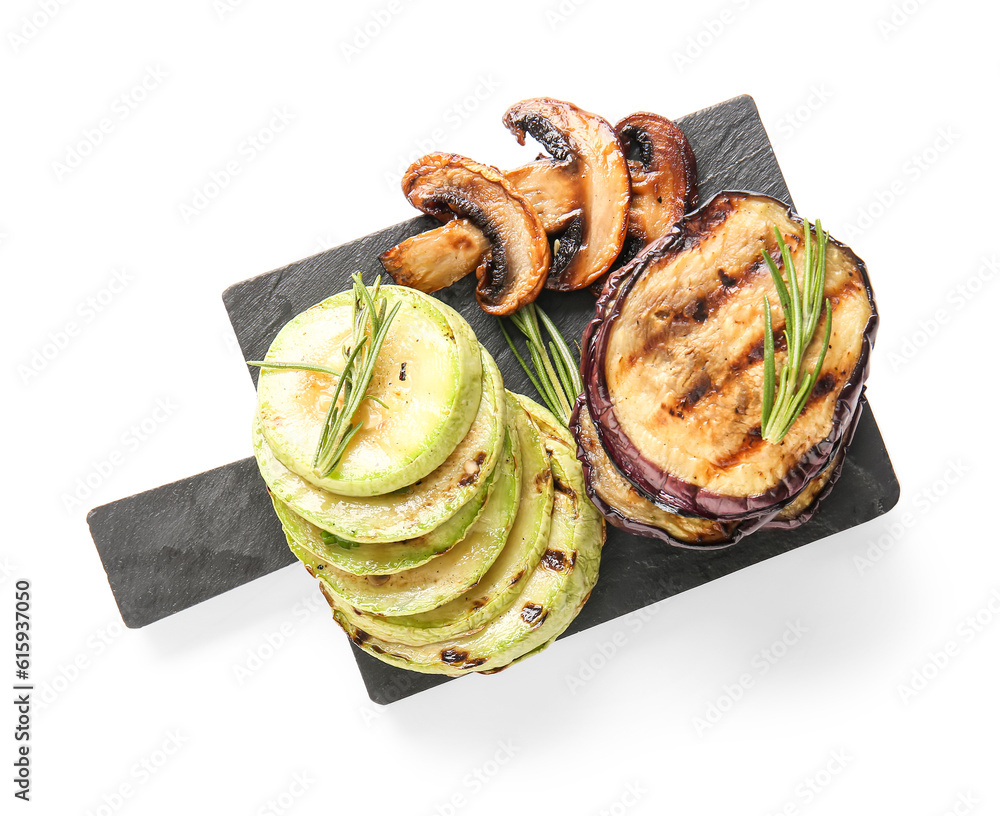 Slate board with different tasty grilled vegetables on white background