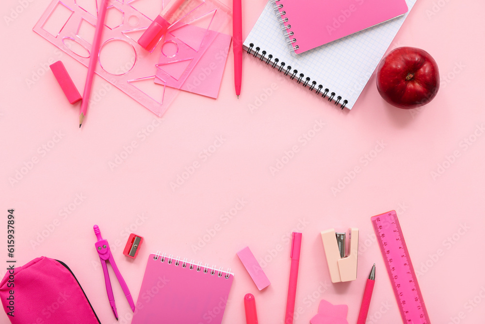 Fresh red apple with pencil case and different stationery on pink background