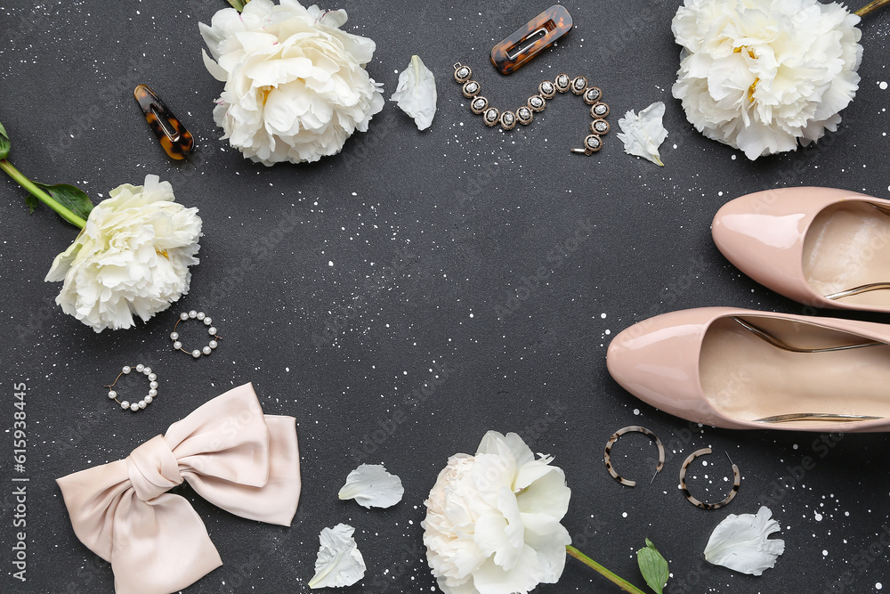 Frame made of stylish female accessories, high heels and beautiful peony flowers on dark background