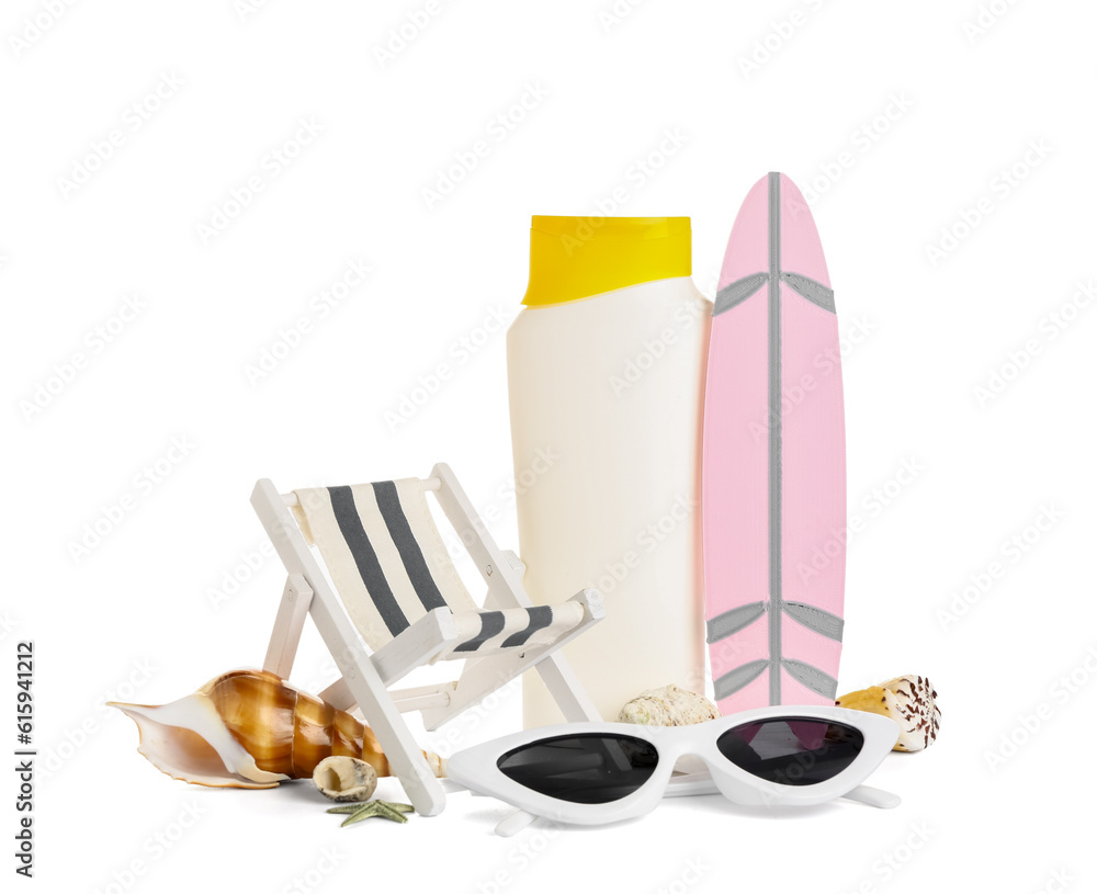 Creative composition with mini surfboard, deckchair, sunglasses and bottle of sunscreen cream isolat