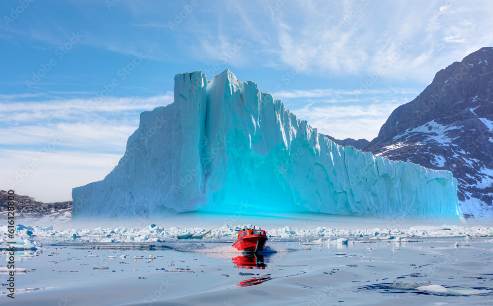 Fast moving motorboat trying to get out of the ice - Stranded icebergs in the fog at the mouth of th