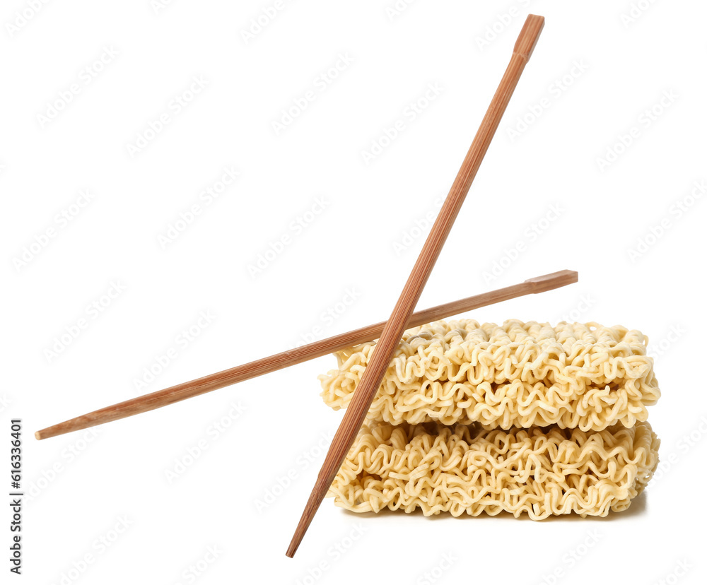 Raw instant noodles and wooden chopsticks on white background