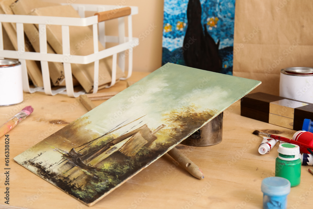 Table with artists supplies and picture in studio