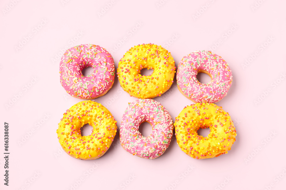 Sweet donuts on pink background