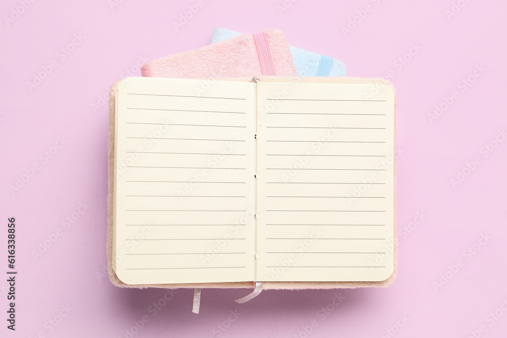 Open notebook on pink background