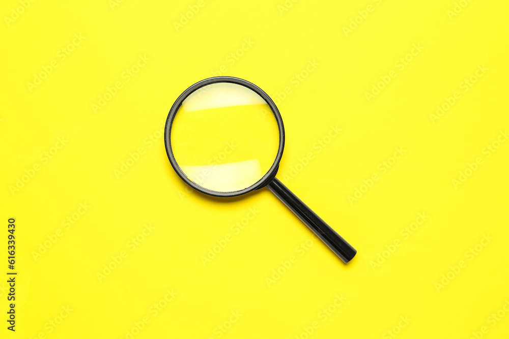 Black magnifiers on yellow background