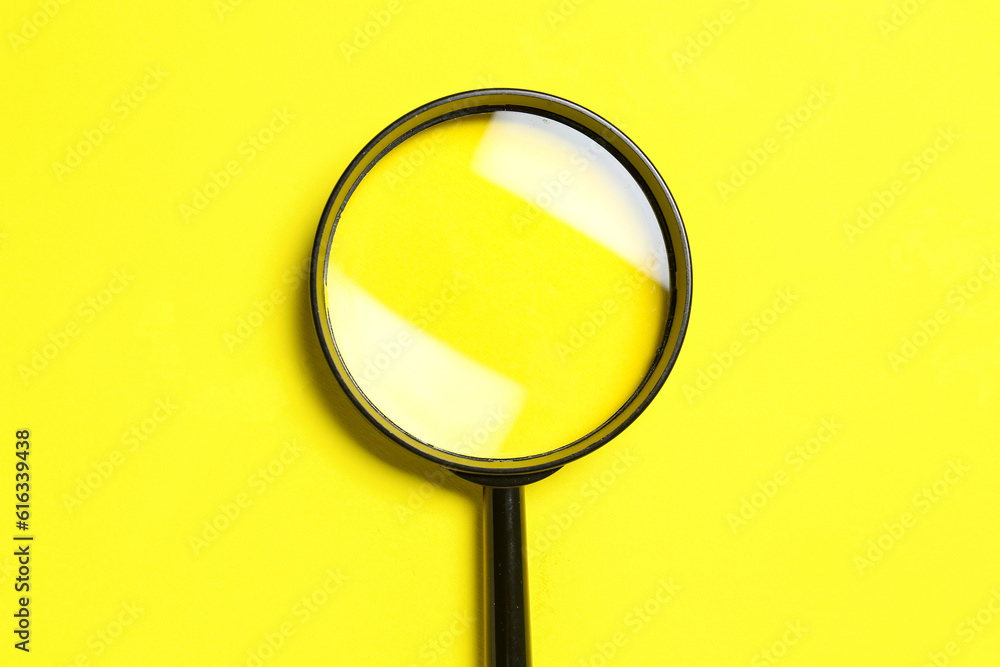 Black magnifiers on yellow background