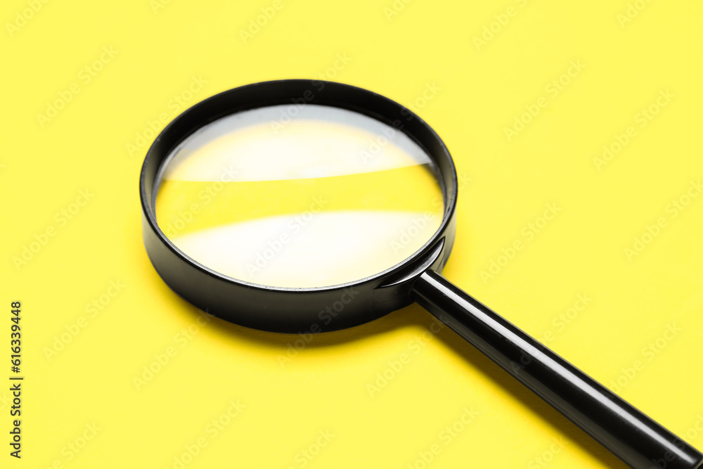 Black magnifiers on yellow background