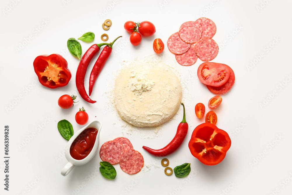 Raw dough and ingredients for preparing pizza on white background