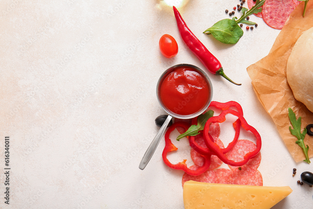 Different ingredients for preparing pizza on light background