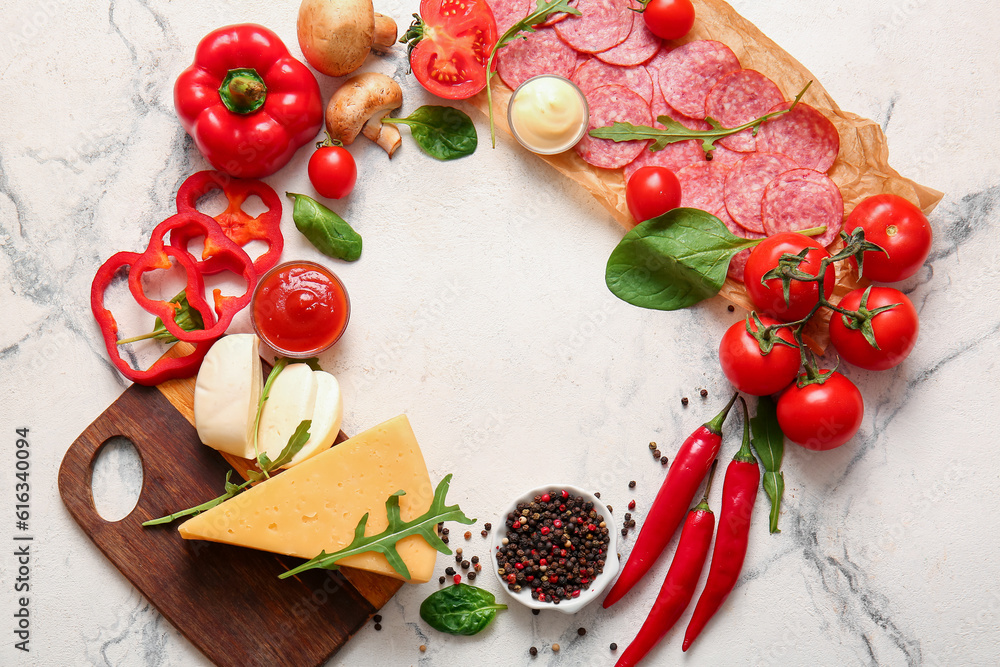 Frame made of ingredients for preparing pizza on white marble background