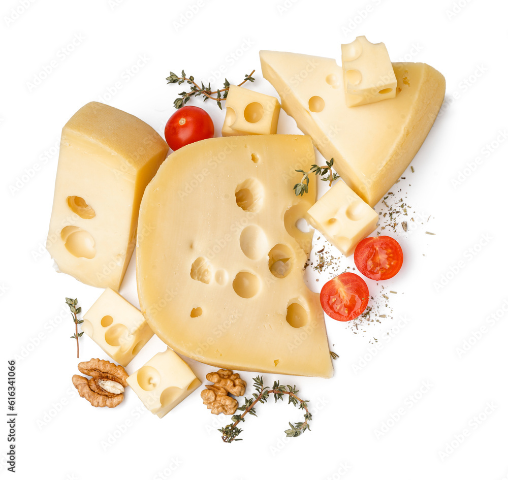 Pieces of Swiss cheese with thyme, tomatoes cherry and walnut on white background