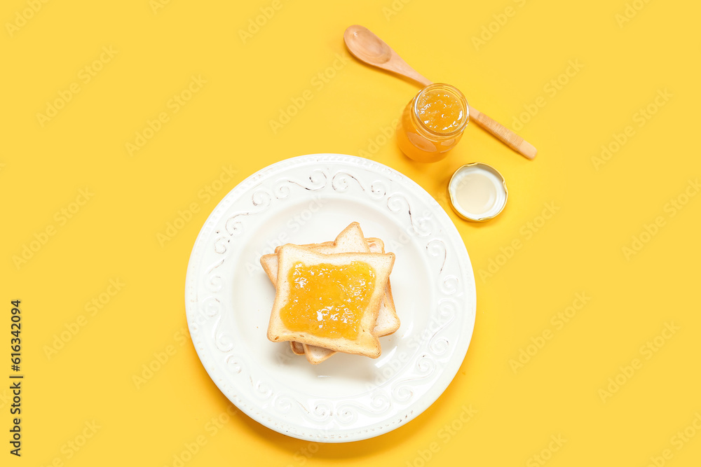 Plate of tasty toasts and jam on color background