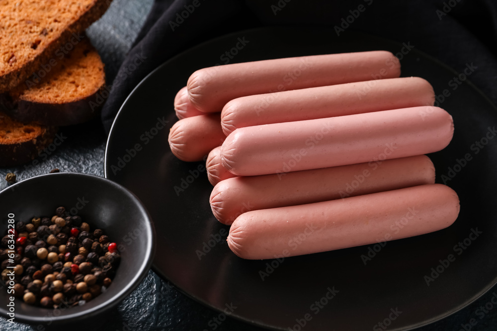 Plate with tasty thin sausages and bread, closeup