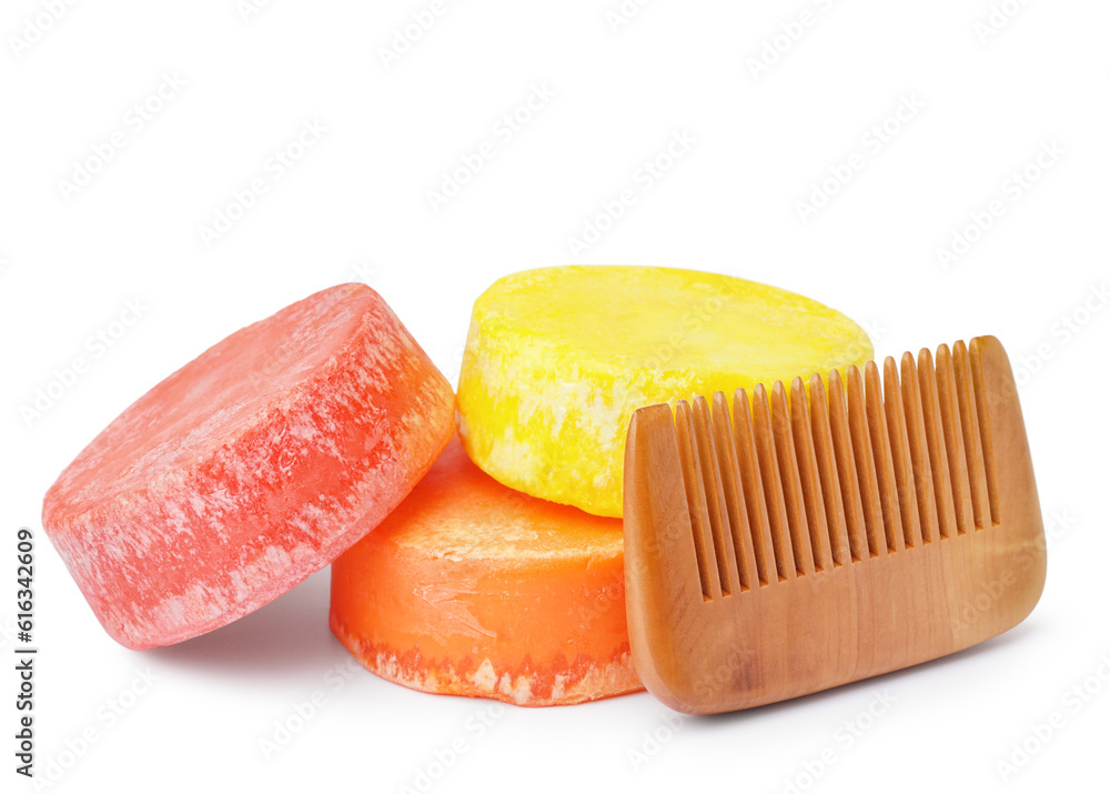 Colorful solid shampoo bars with comb on white background