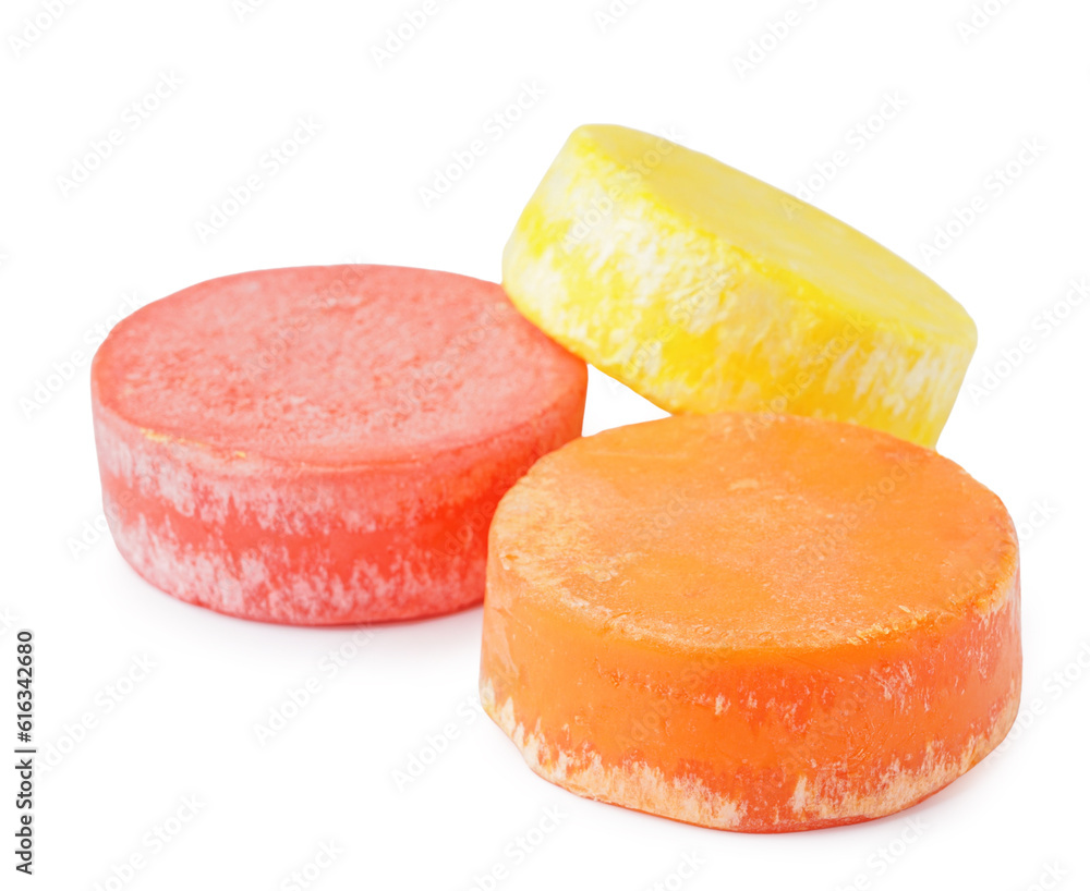 Colorful solid shampoo bars on white background