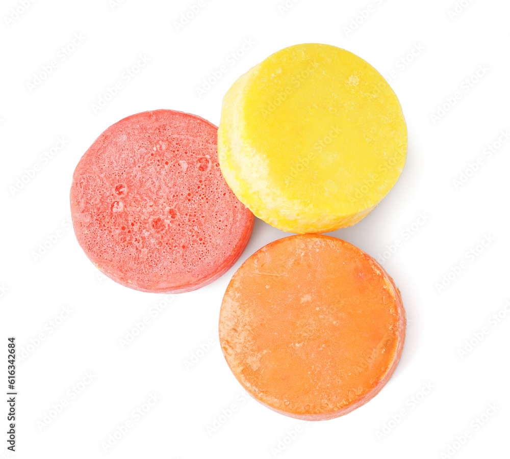 Colorful solid shampoo bars on white background