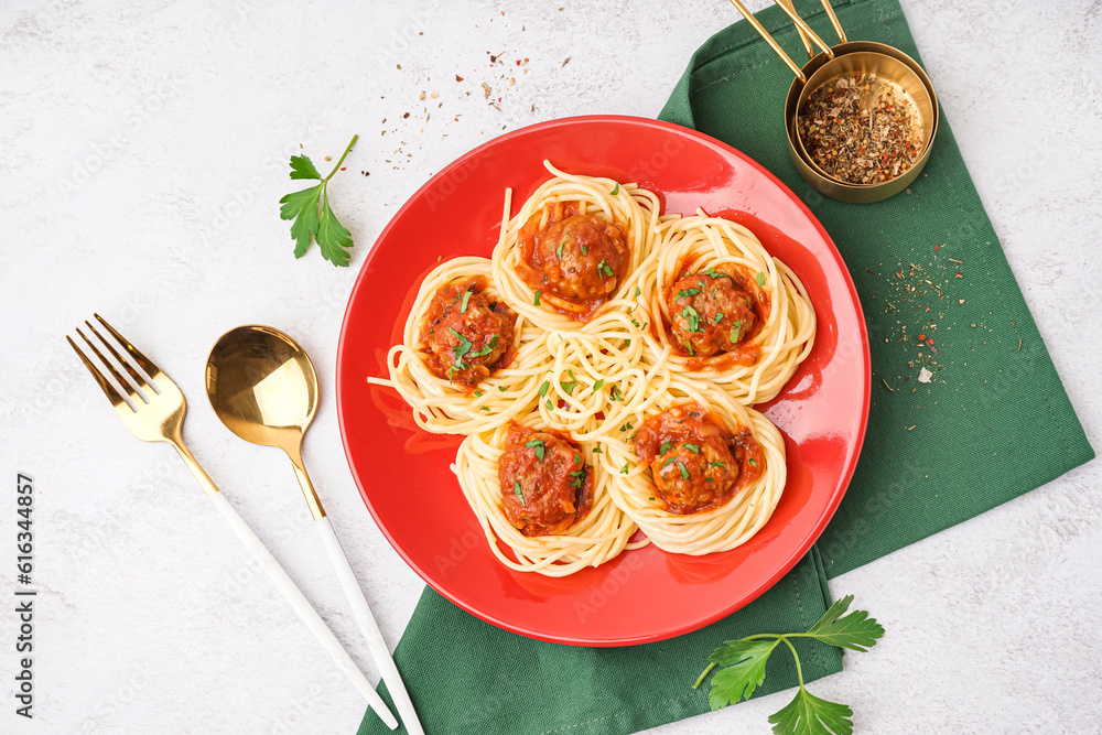 Plate of boiled pasta with tomato sauce and meat balls on white background