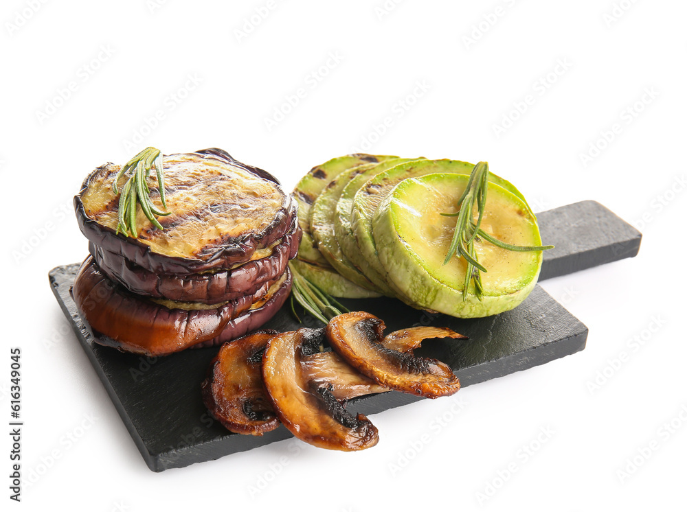 Slate board with different tasty grilled vegetables on white background