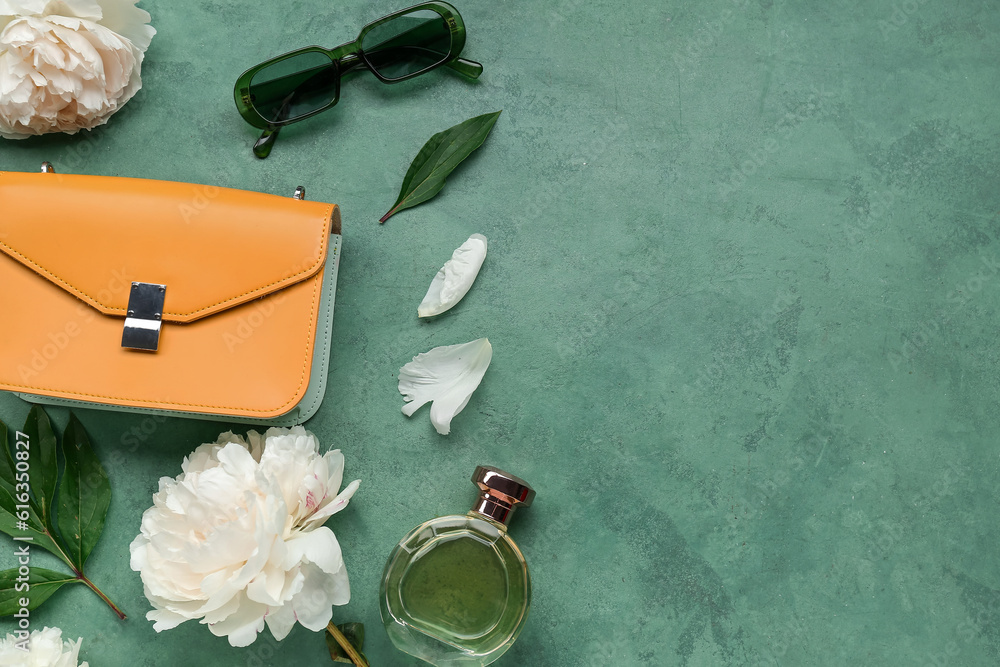 Composition with stylish female accessories, bottle of perfume and beautiful peony flowers on color 