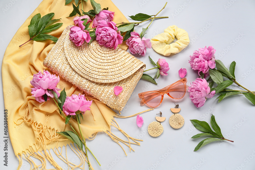 Composition with stylish female accessories and beautiful peony flowers on light background