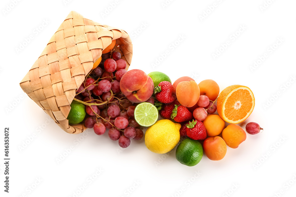 Wicker basket with different fresh fruits on white background