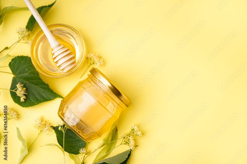 Glass bowl and jar with linden honey on yellow background