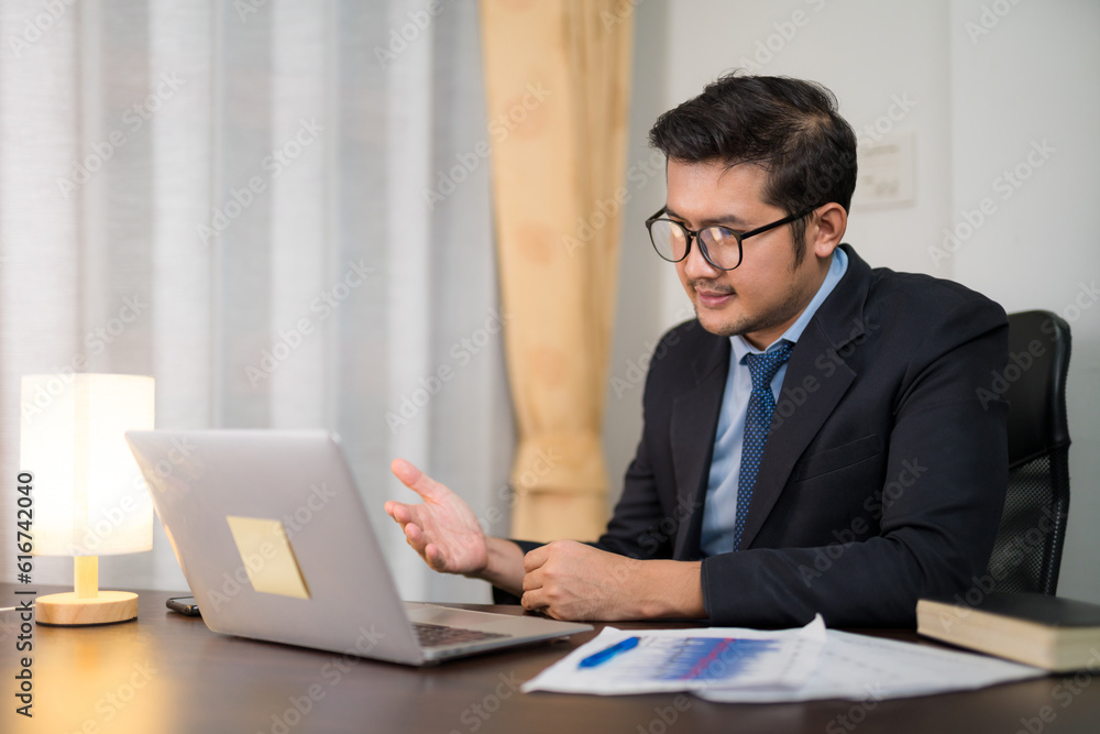 Asian young business people meeting online Introduce and clarify company sales with laptop on desk f