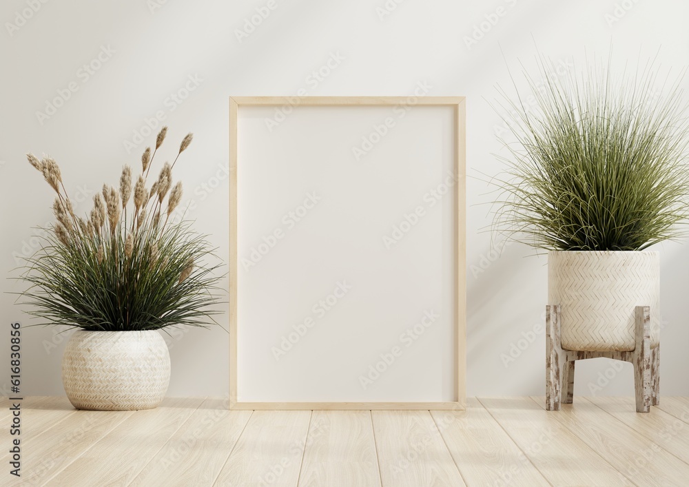 Poster frame mockup with plant pot in room with white wall.