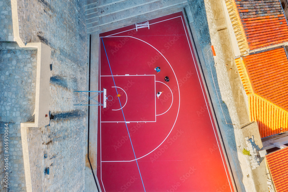 Healthy lifestyle. A team plays basketball on the court. The view from the air on the basketball pla