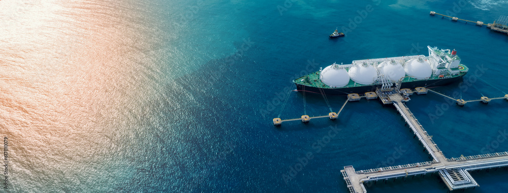 LNG (Liquified Natural Gas) tanker anchored in Gas terminal gas tanks for storage. Oil Crude Gas Tan