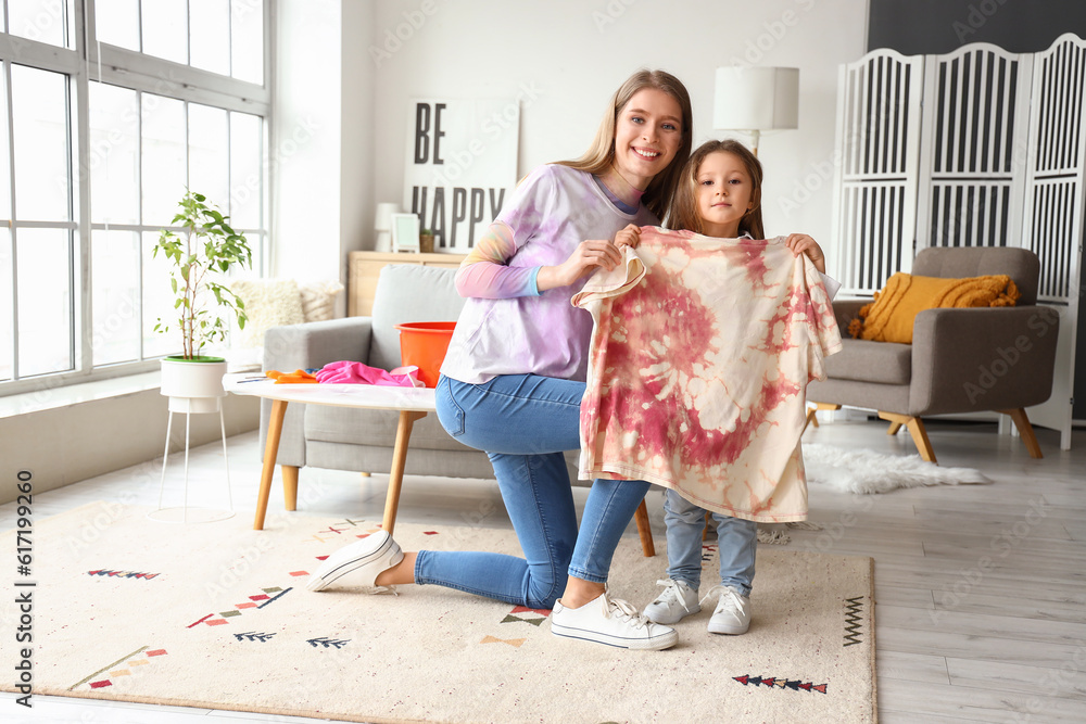 Little girl with her sister and tie-dye t-shirt at home