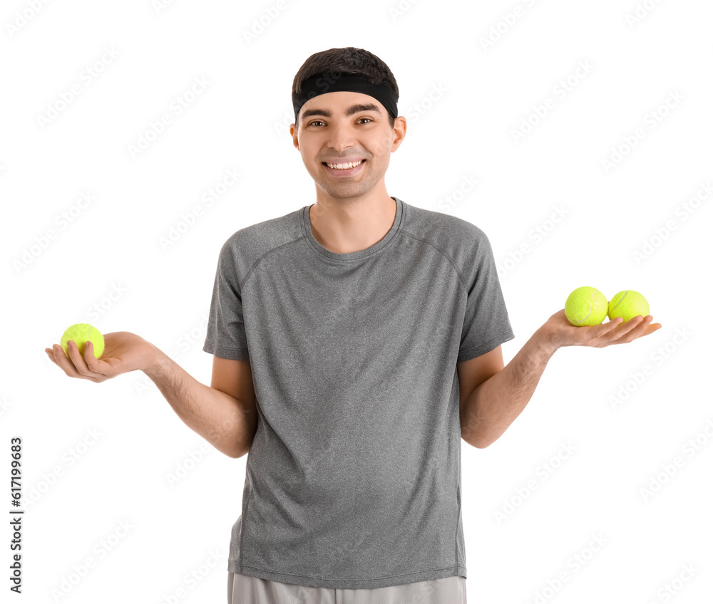 Sporty young man with tennis balls on white background. Balance concept