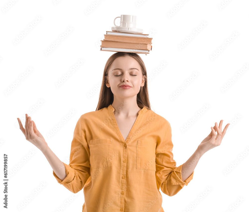 Young woman with cup and books meditating on white background. Balance concept