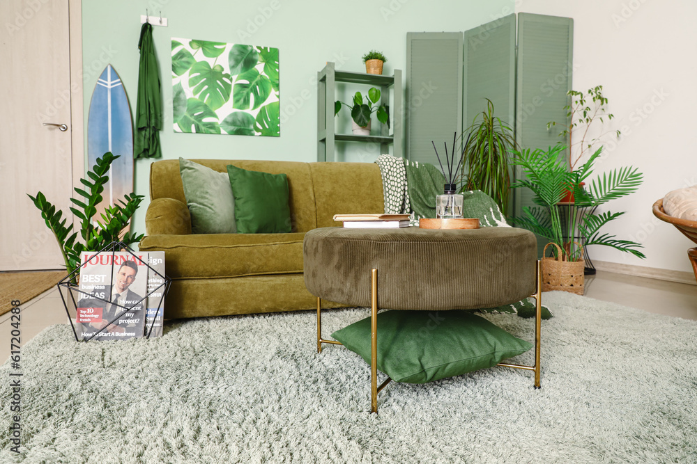 Interior of stylish living room with surfboard and sofa