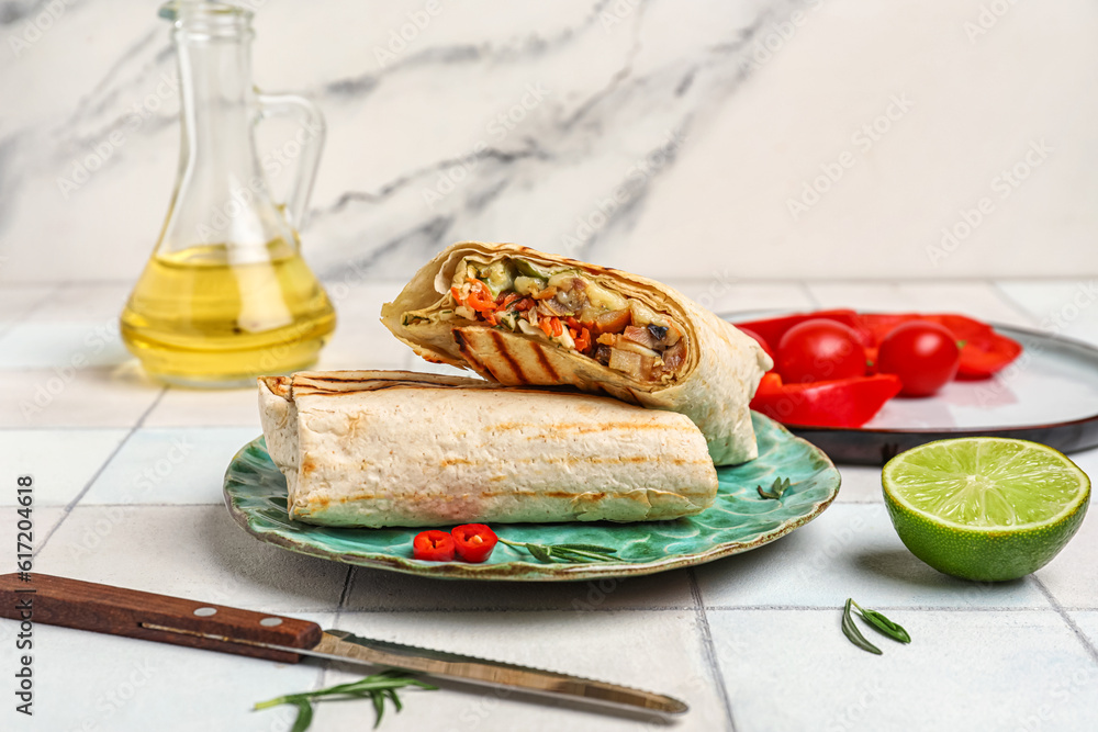 Plates with tasty shawarma with pepper on white tile table