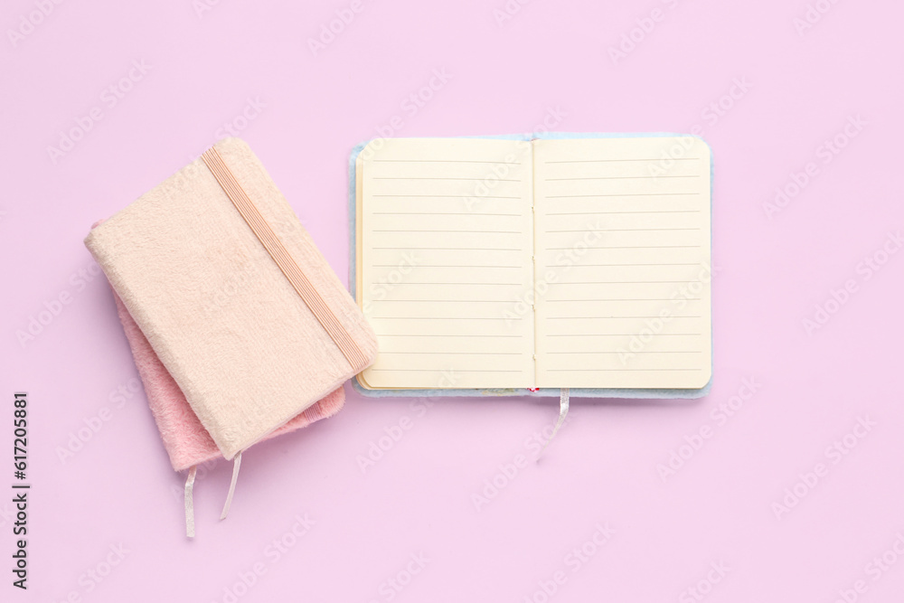 Set of notebooks on pink background