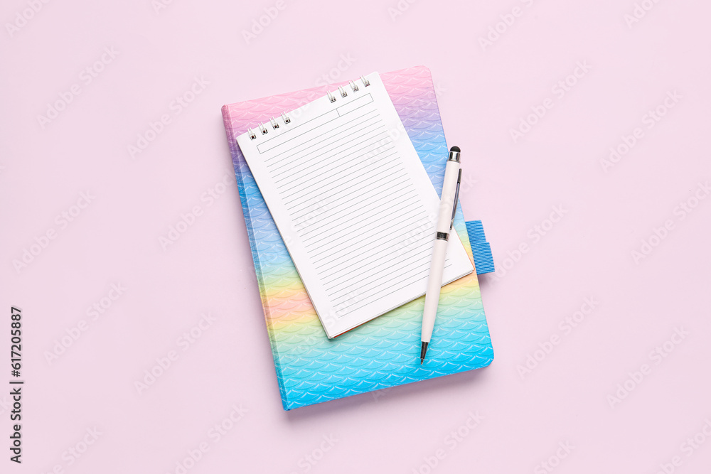 Notebooks with pen on pink background