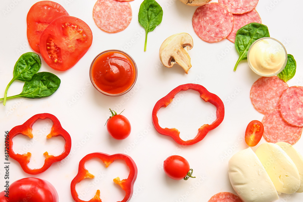 Fresh ingredients for preparing pizza on white background