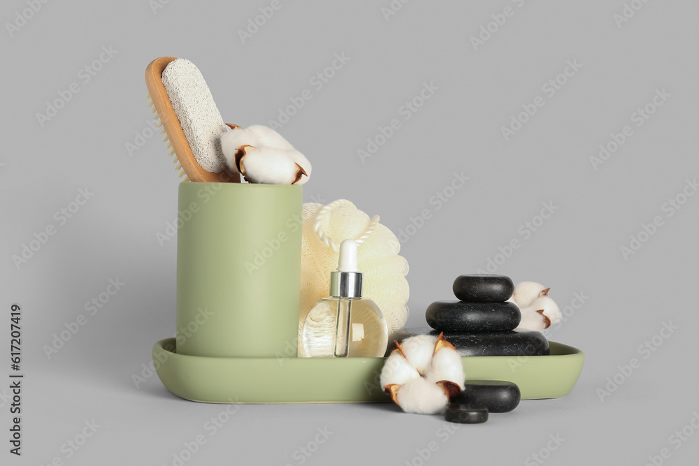 Set of bath supplies and cotton flowers on white background