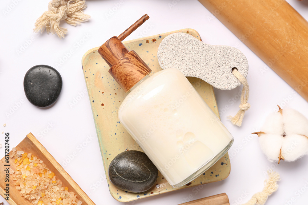 Composition with bottle of cosmetic product, bath supplies and cotton flower on white background, cl