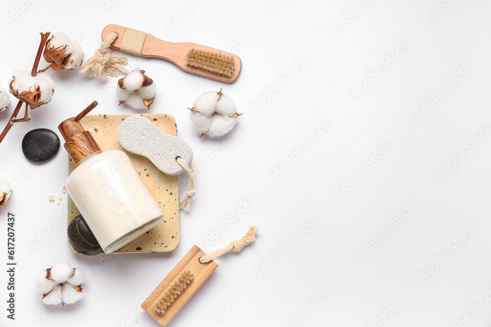 Composition with bottle of cosmetic product, bath supplies and cotton flowers on white background